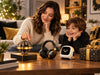Parent and child comparing tech gifts including Flyokay MemoOrb, headphones, and an interactive robot at home