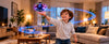 Child playing indoors with a Flyokay MemoOrb flying orb ball following a curved light trail in a living room