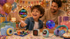 Child playing with Flyokay MemoOrb displaying a colorful Happy Birthday LED message at a birthday party