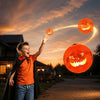 Child playing outdoors with Flyokay MemoOrb showing glowing jack-o-lantern LED graphics during a Halloween-themed flying activity