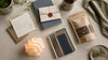 Thoughtful gift ideas for someone who has everything, including a handwritten note, sealed letter, pencils, and a small snack gift